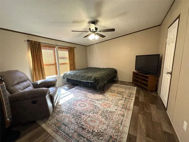 a living room with couches and a flat screen tv