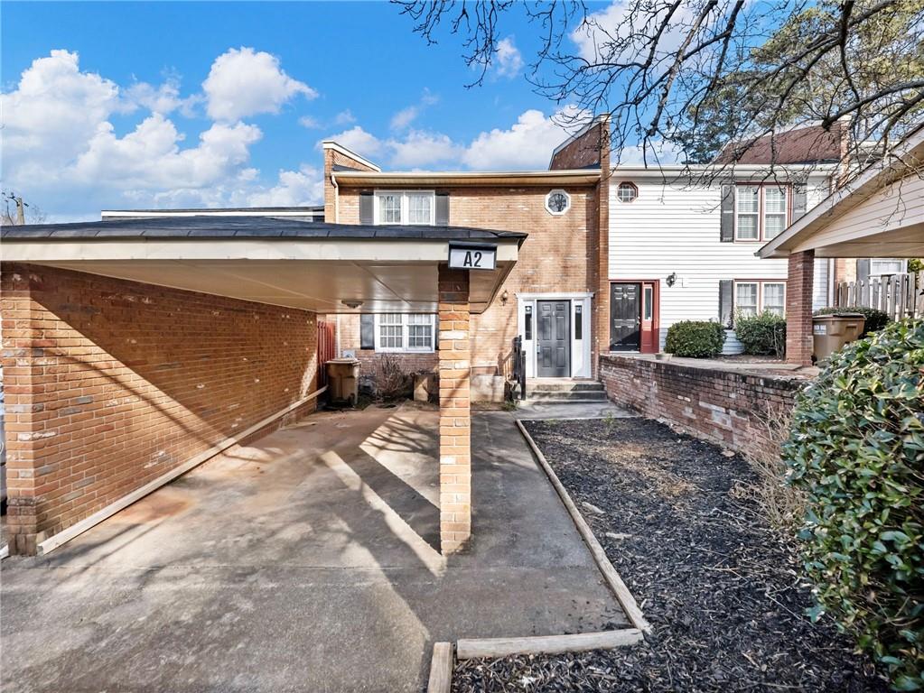 6500 Gaines Ferry Road, Unit A2 Flowery Branch, GA 30542 - Photo 1 of 42 a view of a patio with couches chairs and a potted plant