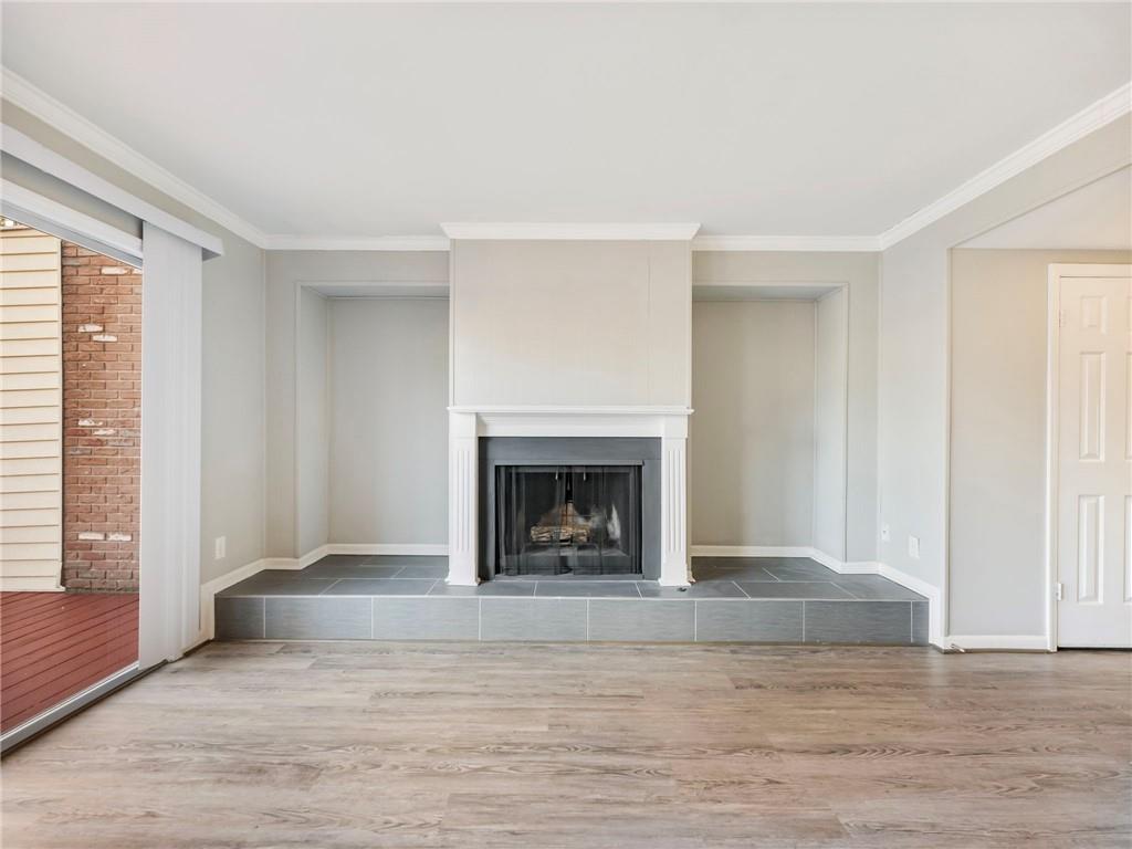 6500 Gaines Ferry Road, Unit A2 Flowery Branch, GA 30542 - Photo 11 of 42 a view of a livingroom with a fireplace and a window