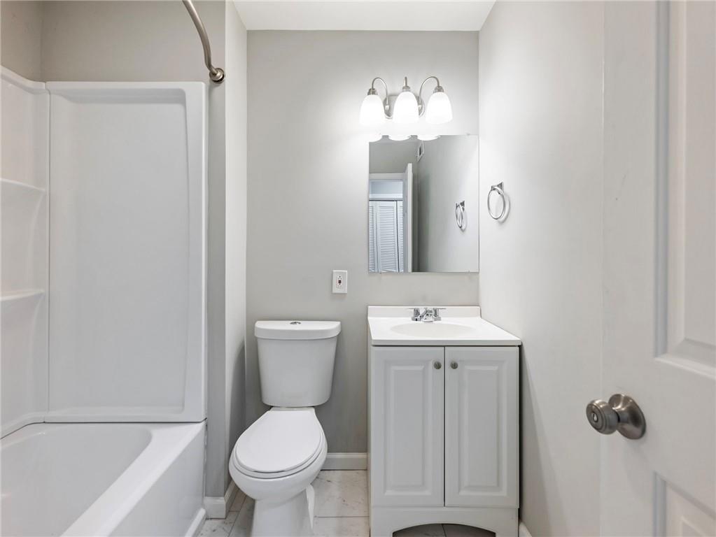 6500 Gaines Ferry Road, Unit A2 Flowery Branch, GA 30542 - Photo 20 of 42 a bathroom with a toilet sink and mirror
