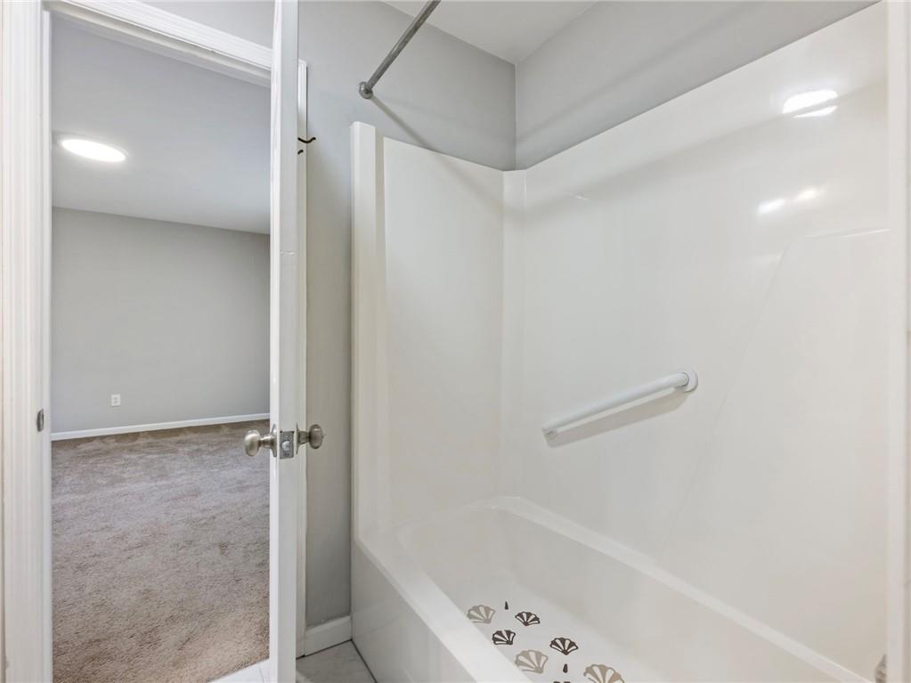 6500 Gaines Ferry Road, Unit A2 Flowery Branch, GA 30542 - Photo 26 of 42 a bathroom with a bathtub and a shower