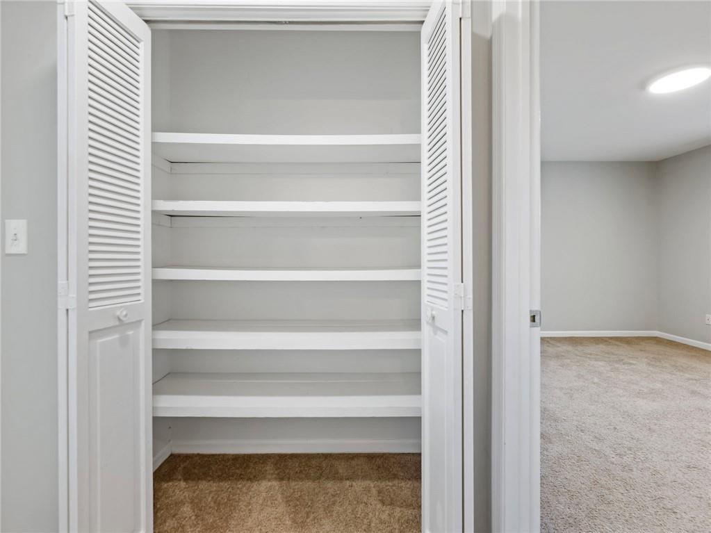 6500 Gaines Ferry Road, Unit A2 Flowery Branch, GA 30542 - Photo 27 of 42 a view of walk in closet with empty racks