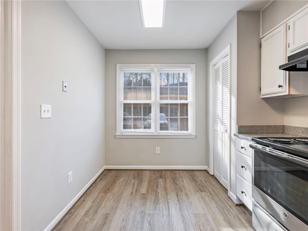 6500 Gaines Ferry Road, Unit A2 Flowery Branch, GA 30542 - Photo 5 of 42 a view of a kitchen with wooden floor and a window