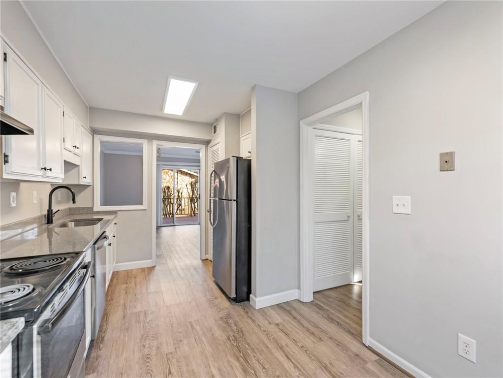 6500 Gaines Ferry Road, Unit A2 Flowery Branch, GA 30542 - Photo 7 of 42 a view of a kitchen with a stove top oven