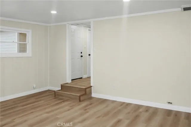 a view of room with stairs and wooden floor