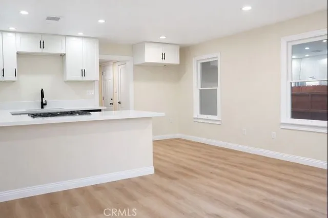 a view of kitchen with wooden floor and windows