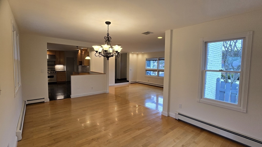 91 Mary Ellen Road Newton, MA 02468 - Photo 12 of 32 a view of a livingroom with a chandelier fireplace and wooden floor