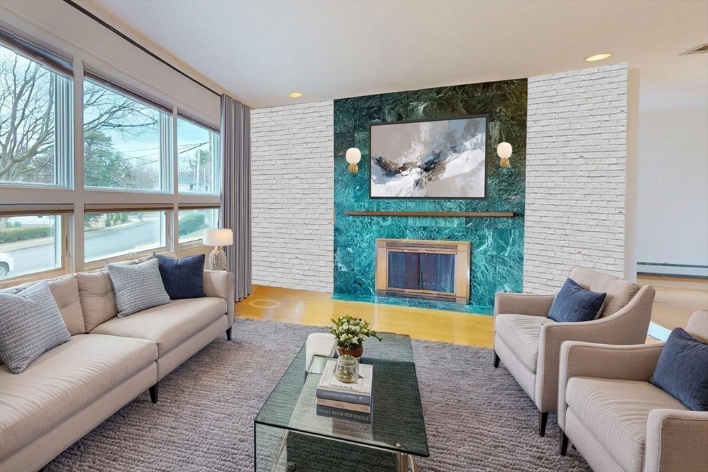 91 Mary Ellen Road Newton, MA 02468 - Photo 16 of 32 a living room with furniture a fireplace and a large window