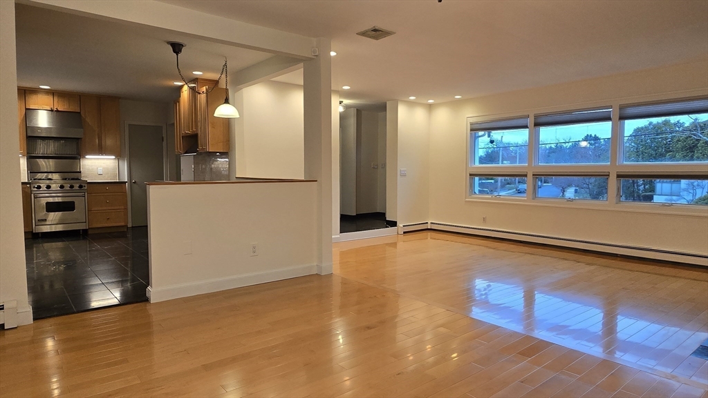 91 Mary Ellen Road Newton, MA 02468 - Photo 18 of 32 a view of a kitchen with a refrigerator and a floor to ceiling window