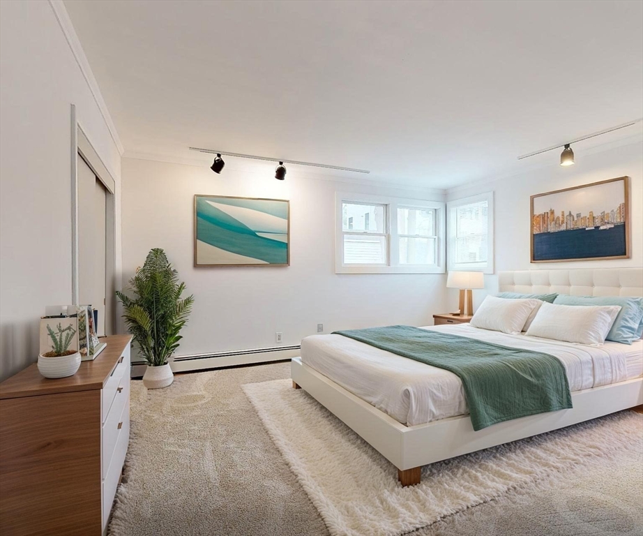 91 Mary Ellen Road Newton, MA 02468 - Photo 19 of 32 a bedroom with a large bed and a flat screen tv