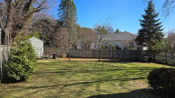 a swimming pool with trees in the background