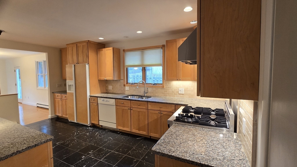 91 Mary Ellen Road Newton, MA 02468 - Photo 10 of 32 a kitchen with stainless steel appliances granite countertop a sink stove and refrigerator