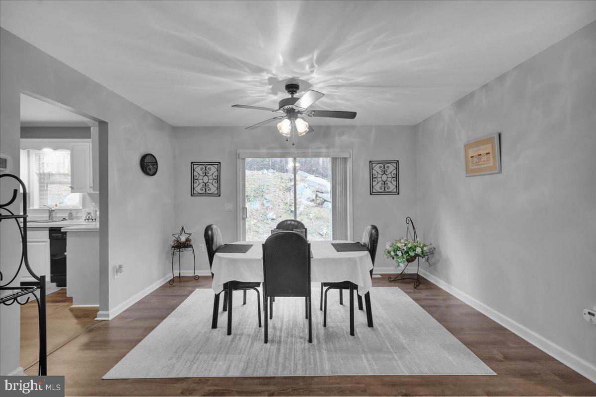 119 Smoketown Road Mertztown, PA 19539 - Photo 17 of 40 a dining room with furniture a floor to ceiling window and wooden floor