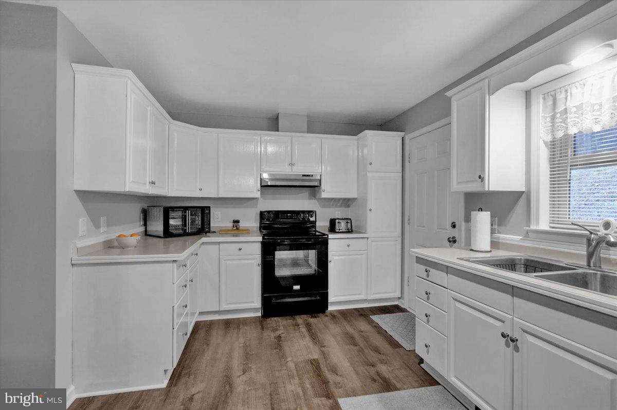 119 Smoketown Road Mertztown, PA 19539 - Photo 19 of 40 a kitchen with white cabinets and appliances