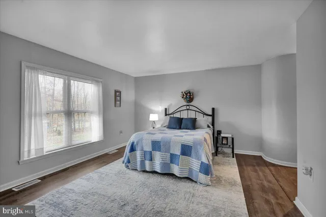 a spacious bedroom with a bed and window