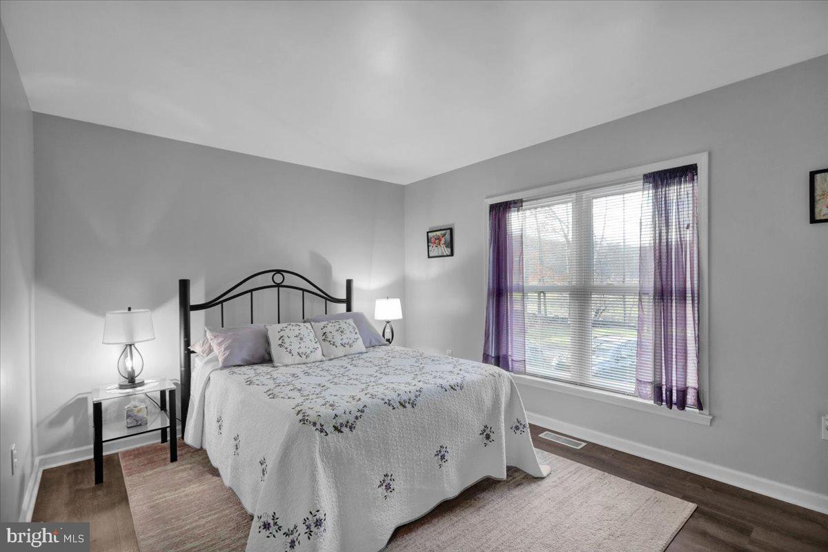 119 Smoketown Road Mertztown, PA 19539 - Photo 27 of 40 a bedroom with a large bed and a window with lamp