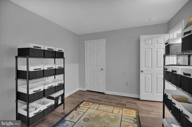 a view of a livingroom with furniture and an empty room