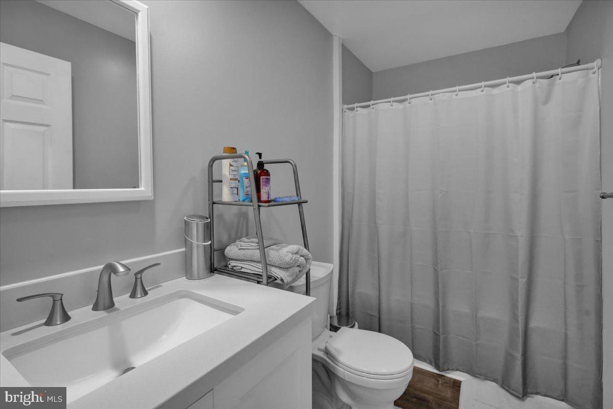 119 Smoketown Road Mertztown, PA 19539 - Photo 31 of 40 a bathroom with a sink a toilet and shower curtain