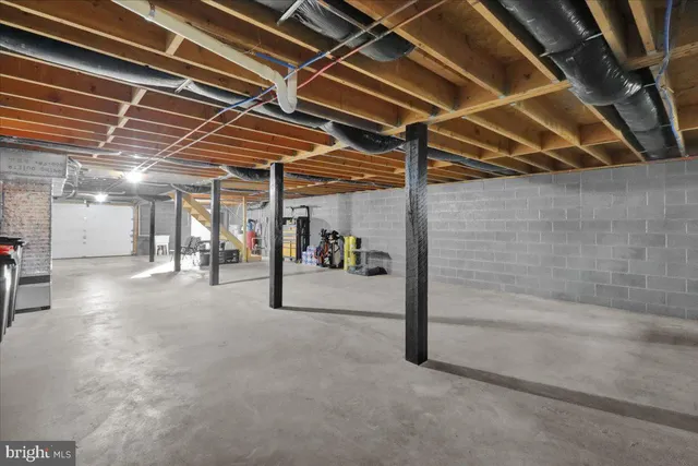 a view of water heater room with two washing machine