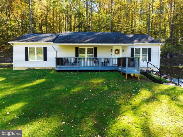 a view of a house with a backyard and a patio