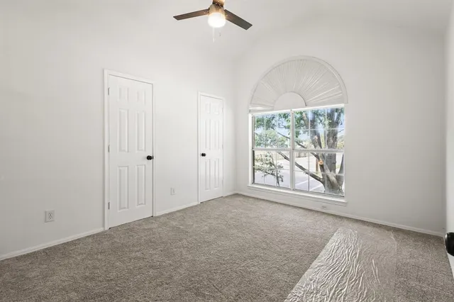 an empty room with windows and exposed bricks
