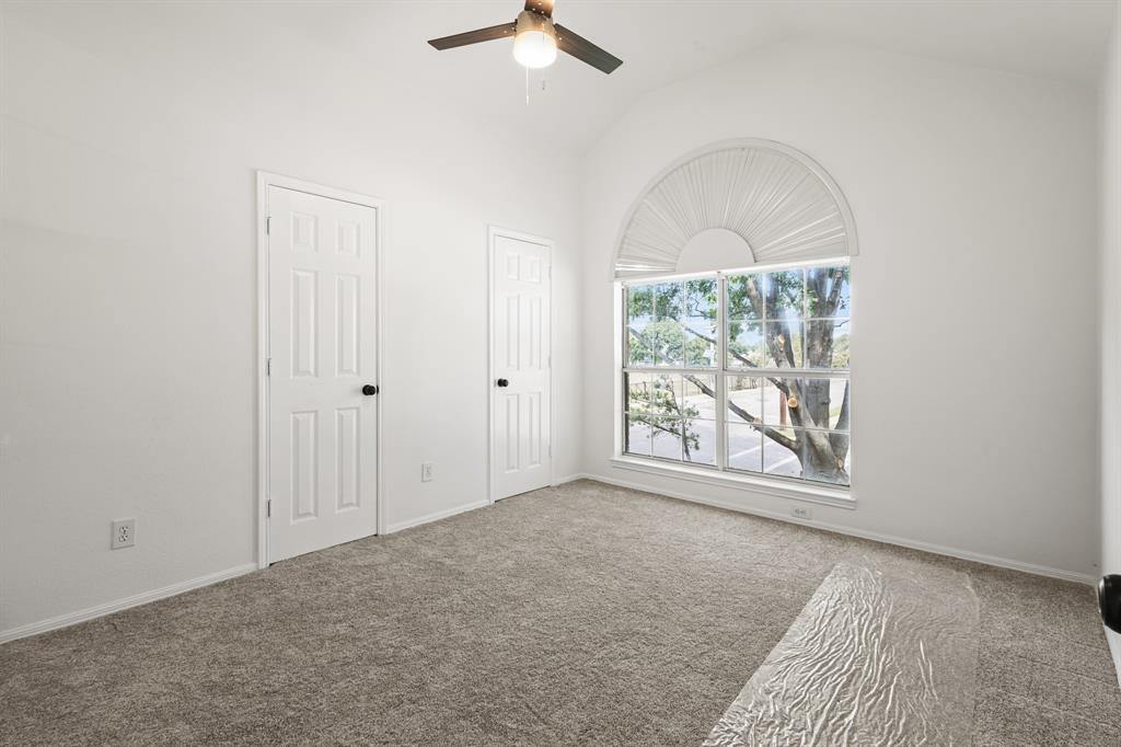 9502 Heartstone Lane Rowlett, TX 75087 - Photo 17 of 22 an empty room with windows and exposed bricks