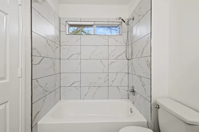 a bathroom with a bathtub and shower