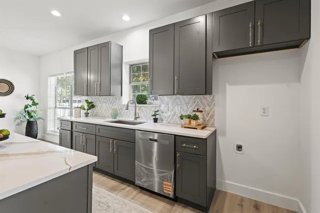 a kitchen with a sink cabinets and window