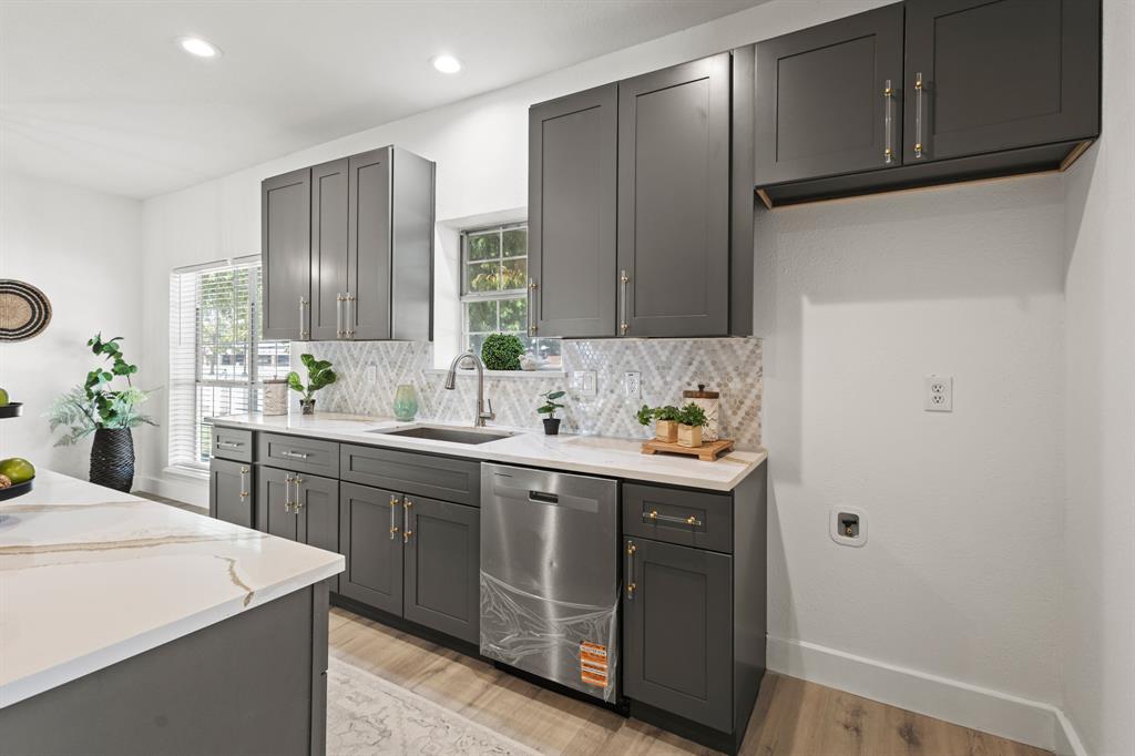 9502 Heartstone Lane Rowlett, TX 75087 - Photo 4 of 22 a kitchen with a sink cabinets and window