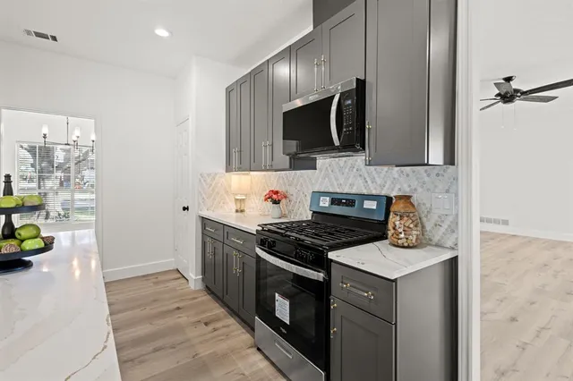 a kitchen with stainless steel appliances granite countertop a stove and a sink