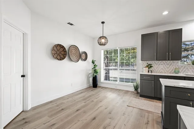 a view of a kitchen with a stove wooden floor and a window