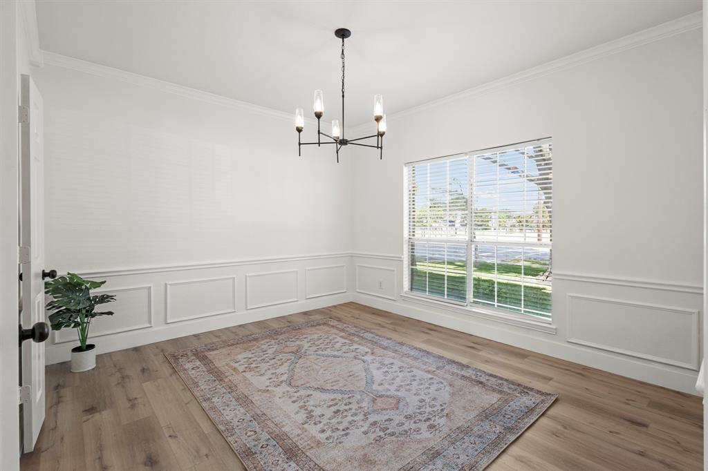 9502 Heartstone Lane Rowlett, TX 75087 - Photo 7 of 22 wooden floor in an empty room with a window