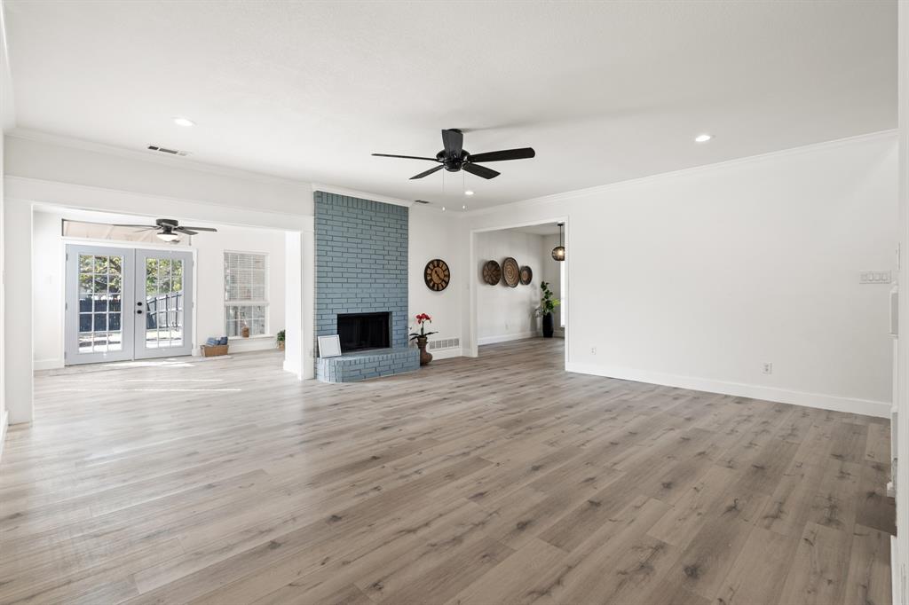 9502 Heartstone Lane Rowlett, TX 75087 - Photo 8 of 22 a view of a livingroom with wooden floor and a ceiling fan