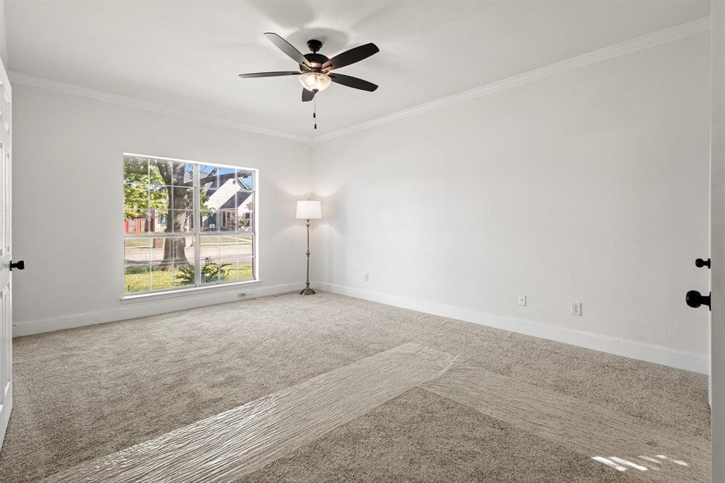 9502 Heartstone Lane Rowlett, TX 75087 - Photo 10 of 22 an empty room with windows and a ceiling fan