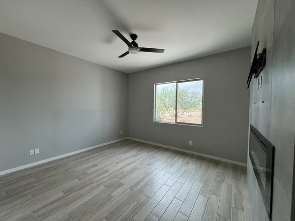 wooden floor in an empty room with a window
