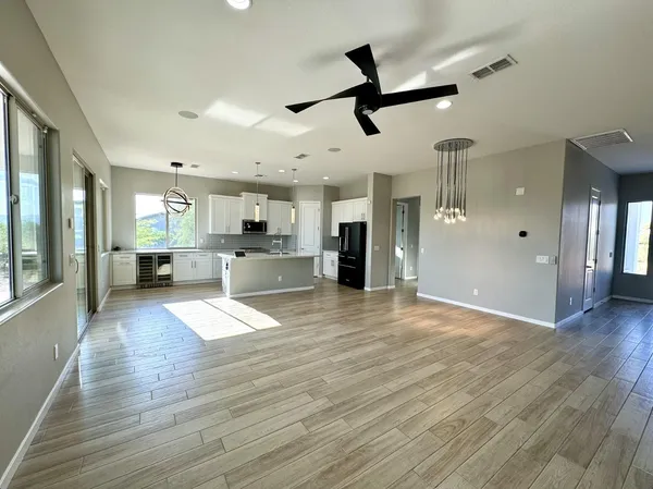 a view of empty room with wooden floor and window