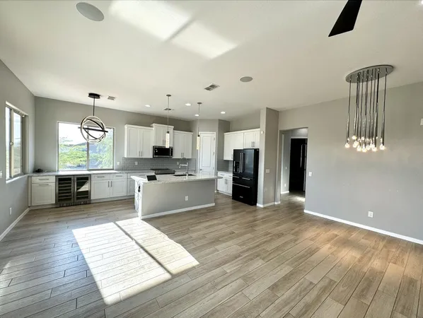 a large kitchen with stainless steel appliances kitchen island granite countertop a stove and a refrigerator