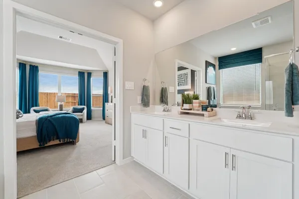 a en suite bathroom with double sink and a mirror