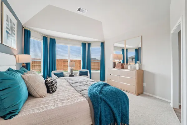 a bedroom with a large bed and a view of bedroom