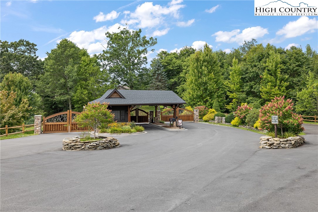 a small pool with a table and chairs under an umbrella