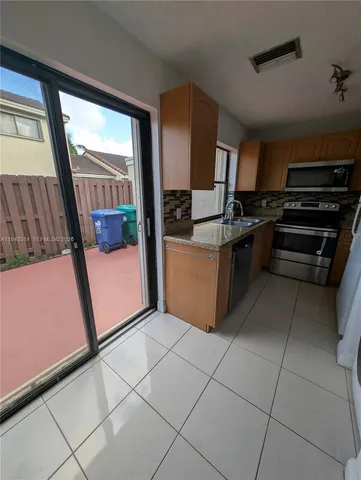 a kitchen with a stove a microwave and a counter top space