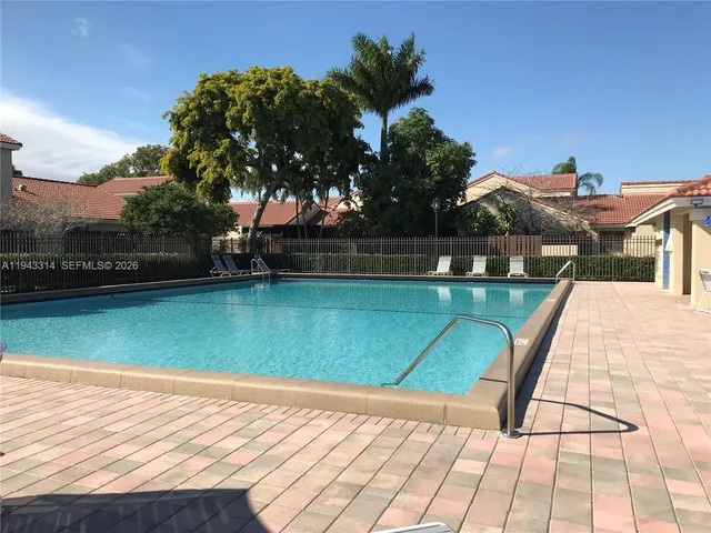 a view of a swimming pool with a yard