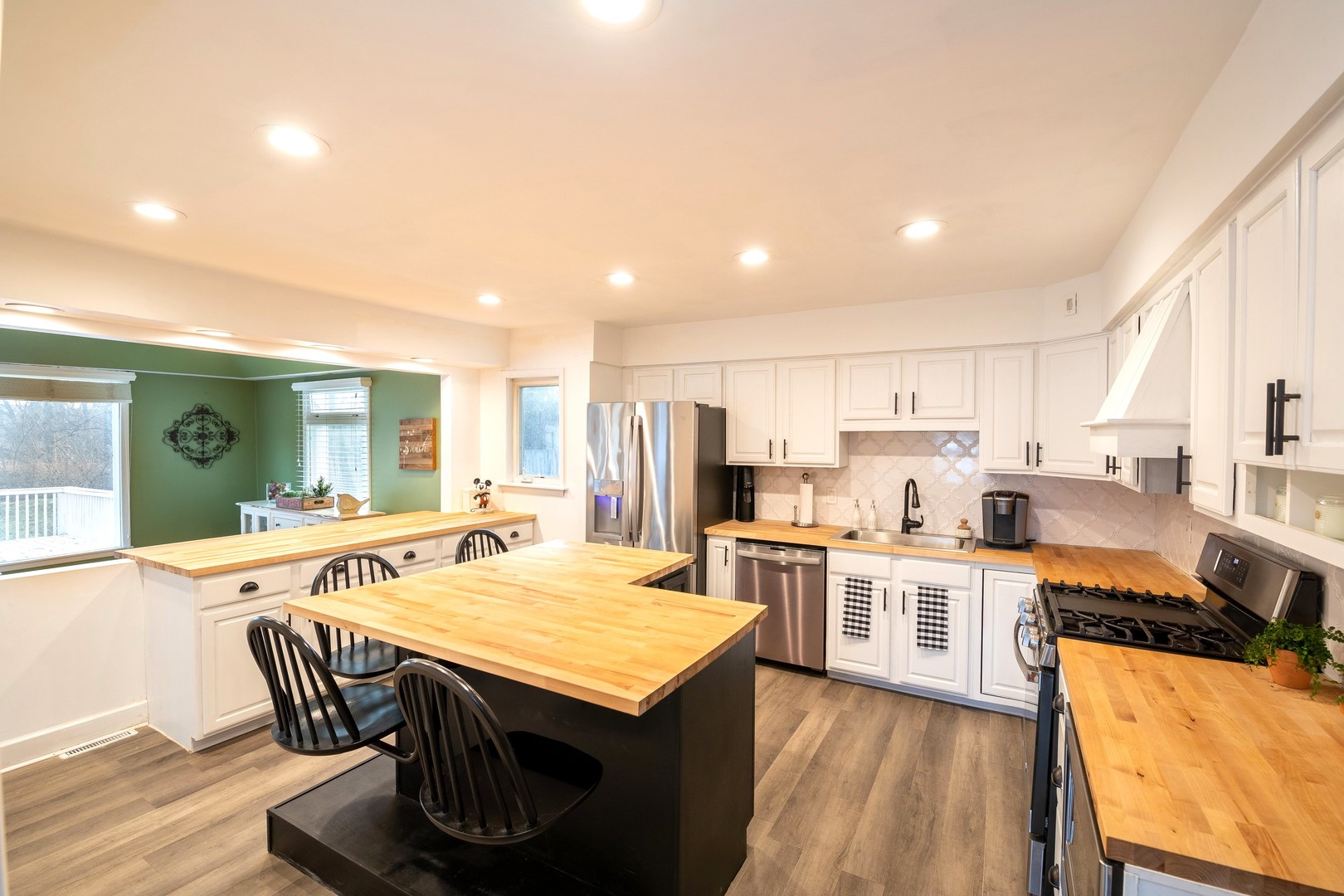 35W657 Park Lane St. Charles, IL 60175 - Photo 27 of 66 a open dining room with stainless steel appliances kitchen island granite countertop a table chairs and a refrigerator