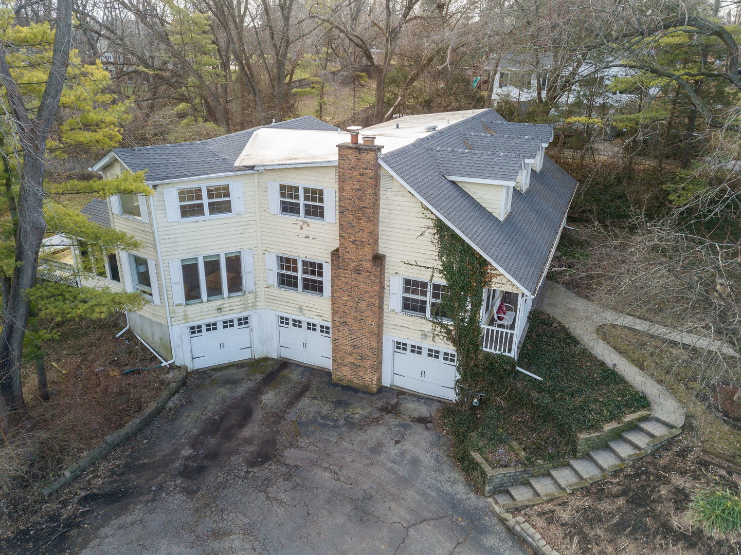 35W657 Park Lane St. Charles, IL 60175 - Photo 8 of 66 a view of a white house next to a road with large trees