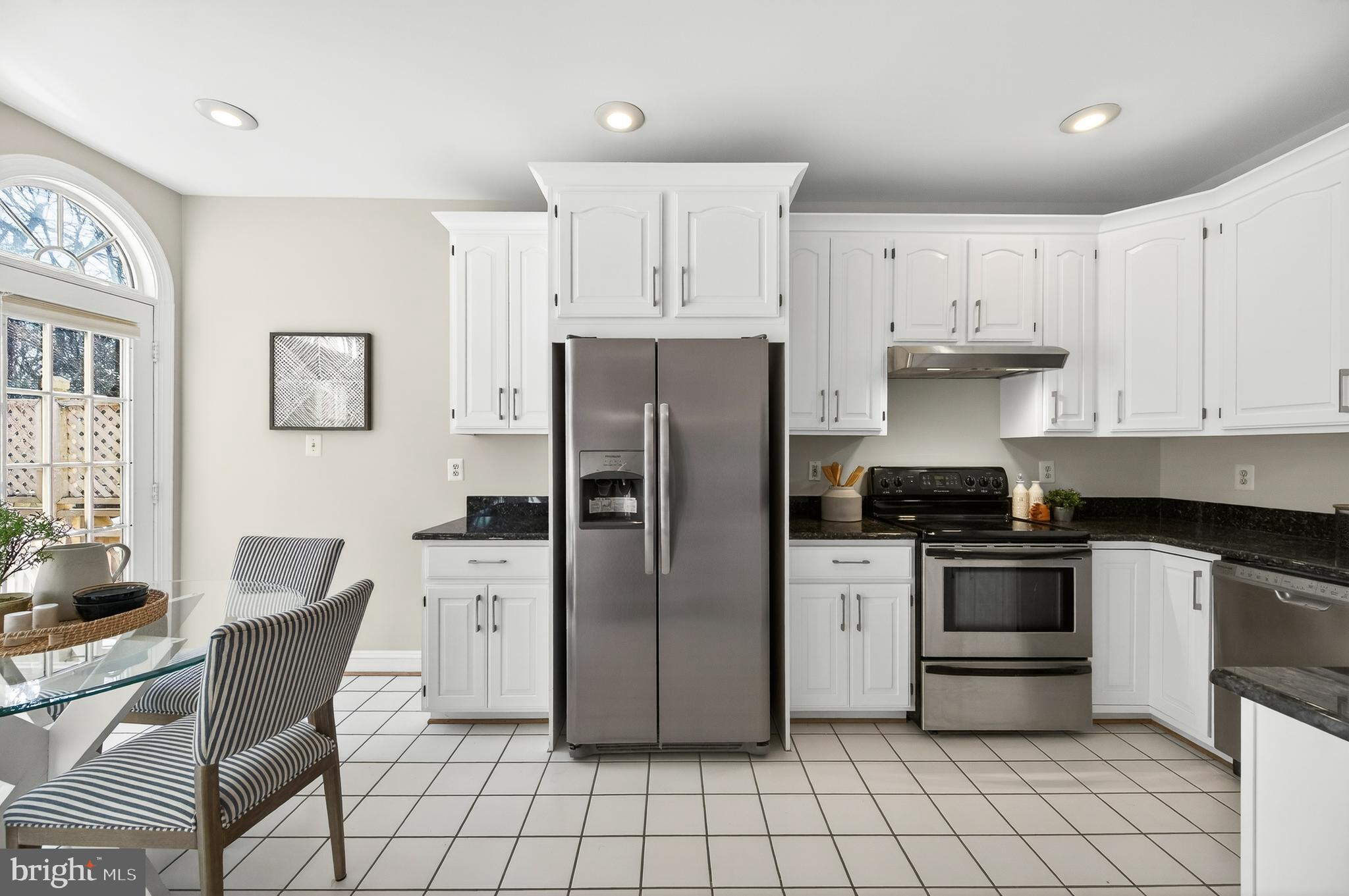 2143 Wolftrap Court Vienna, VA 22182 - Photo 14 of 49 a kitchen with stainless steel appliances granite countertop a refrigerator and a stove top oven