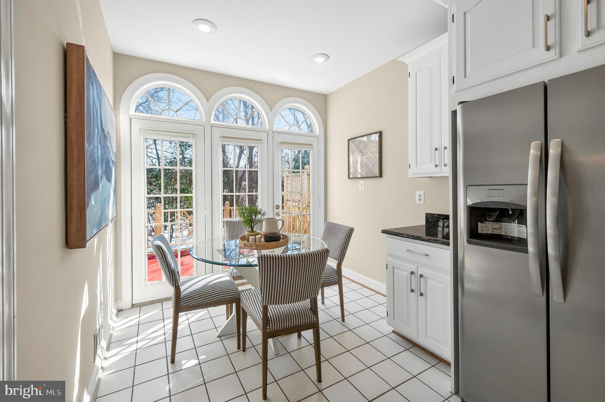 2143 Wolftrap Court Vienna, VA 22182 - Photo 15 of 49 a view of a kitchen with a dining table and chairs