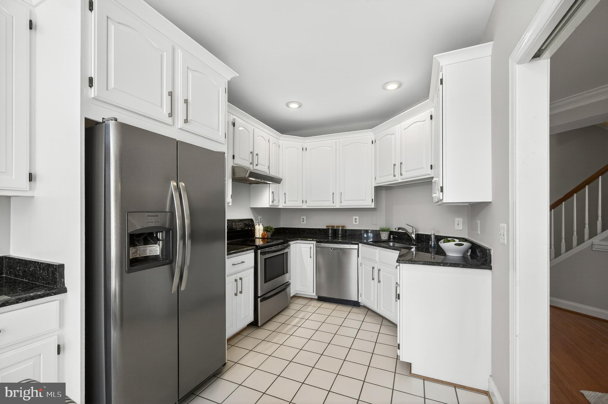 2143 Wolftrap Court Vienna, VA 22182 - Photo 16 of 49 a kitchen with stainless steel appliances granite countertop a refrigerator sink and cabinets