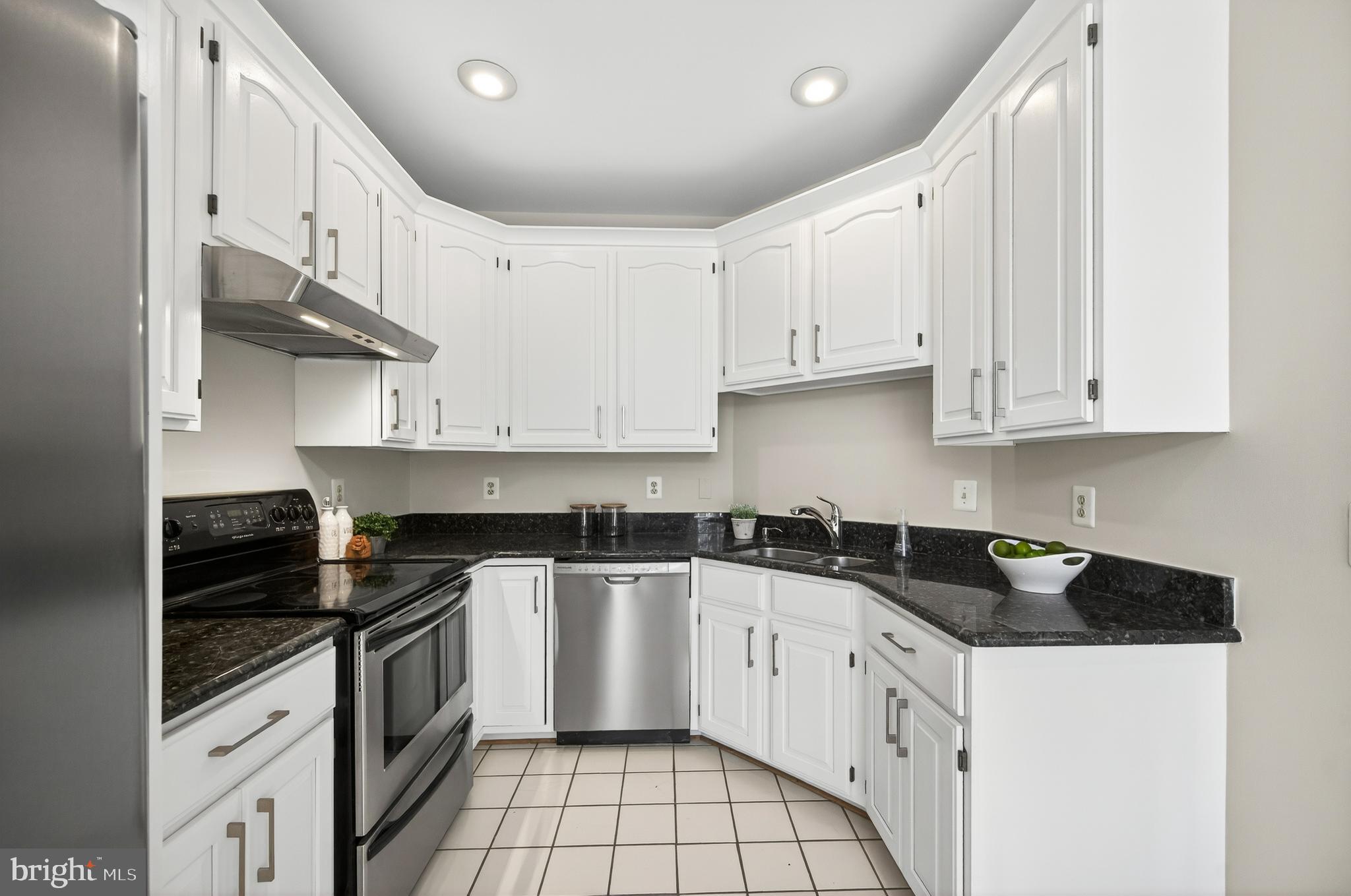 2143 Wolftrap Court Vienna, VA 22182 - Photo 17 of 49 a kitchen with granite countertop a sink a stove and cabinets
