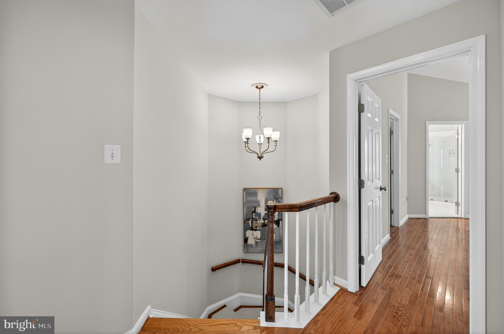 2143 Wolftrap Court Vienna, VA 22182 - Photo 20 of 49 a view of a hallway with wooden floor and stairs