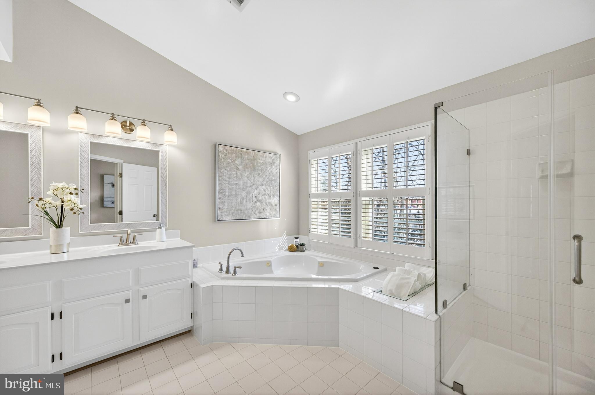 2143 Wolftrap Court Vienna, VA 22182 - Photo 27 of 49 a spacious bathroom with a double vanity sink a mirror and a bathtub